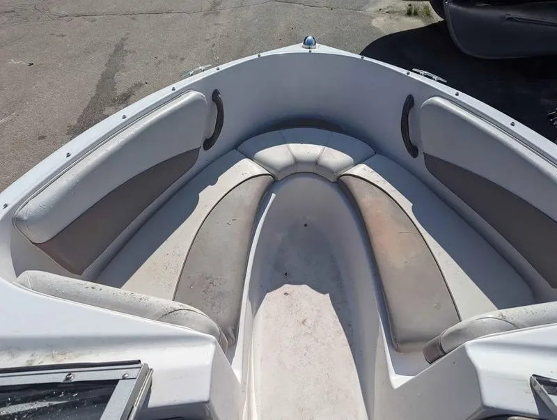 Slide: The Image of 2003 Four Winns Freedom 170 boat interior with cushioned seating and storage compartments. - 7