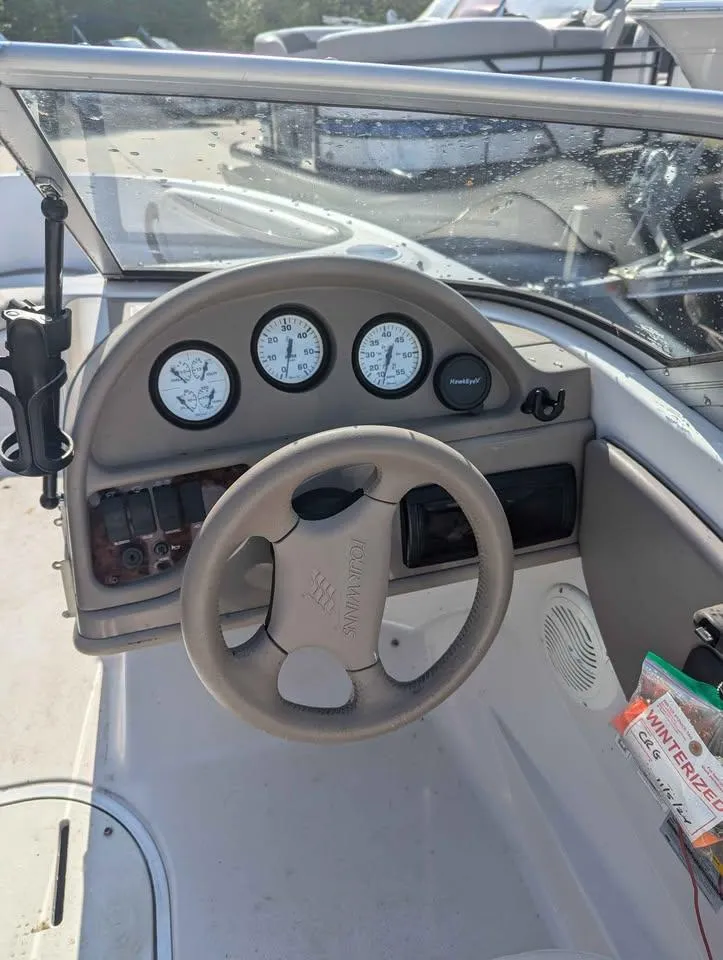 Slide: The Image of 2003 Four Winns Freedom 170 boat dashboard with steering wheel and gauges. - 8