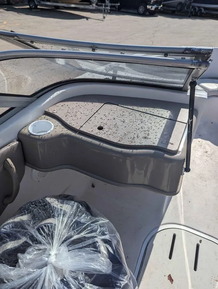 Slide: The Image of 2003 Four Winns Freedom 170 boat interior with seating and windshield. - 9