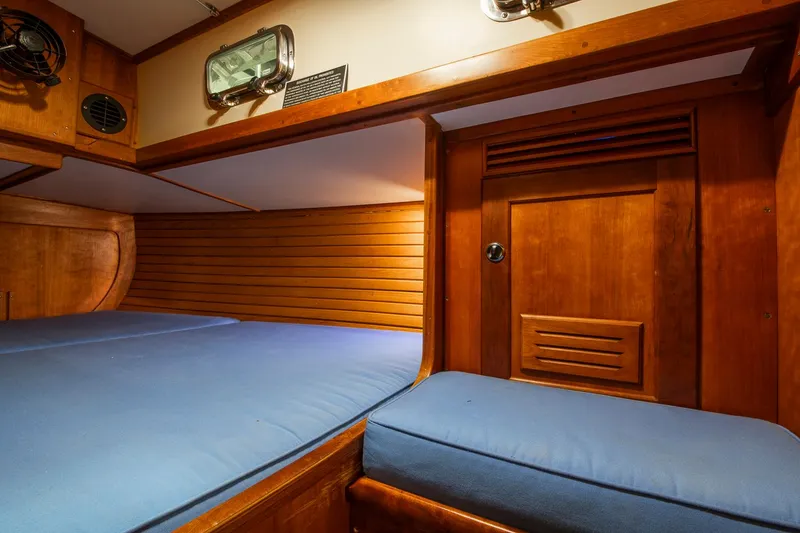 Slide: The Image of Cozy cabin interior of 1997 Valiant 42 sailboat with wooden finish and blue bedding. - 14
