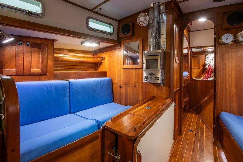 Slide: The Image of Interior of 1997 Valiant 42 sailboat with blue seating and wooden finishes. - 22
