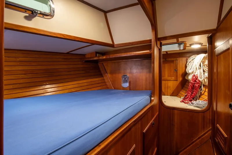 Slide: The Image of Cozy wooden cabin interior of 1997 Valiant 42 sailboat with blue mattress. - 28