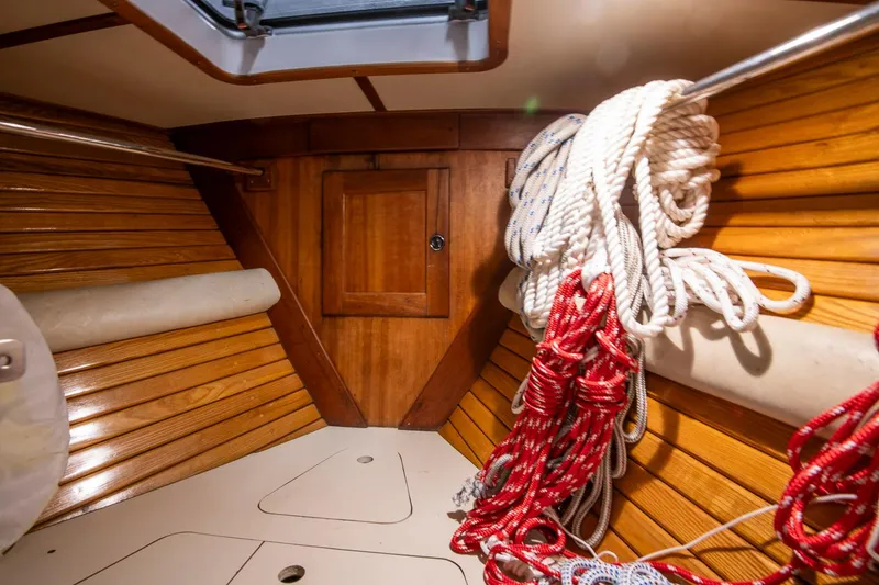Slide: The Image of Interior of 1997 Valiant 42 sailboat with wooden paneling and coiled ropes. - 29