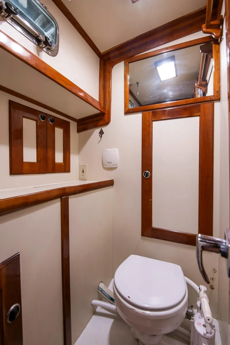 Slide: The Image of Valiant 42 yacht bathroom, 1997 model, featuring wooden trim and compact design. - 37