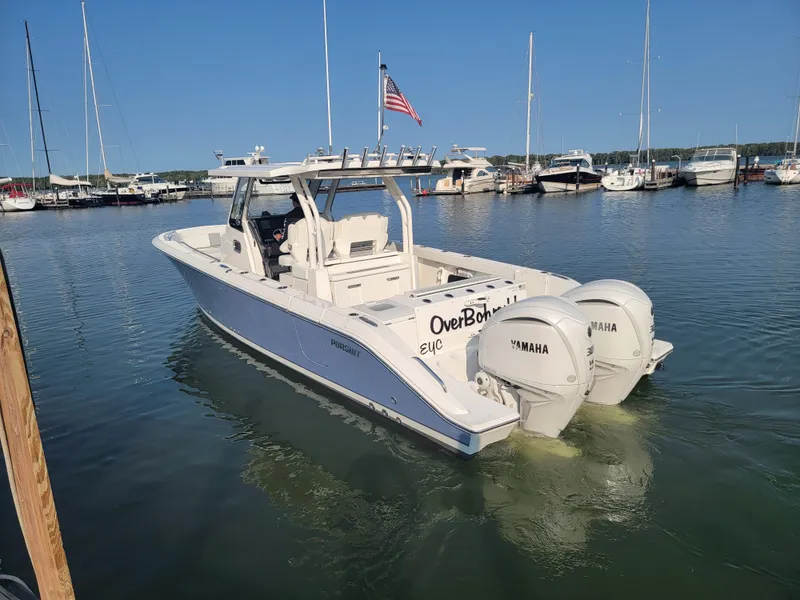 Slide: The Image of 2023 Pursuit S 328 Sport boat docked with twin Yamaha engines. - 33