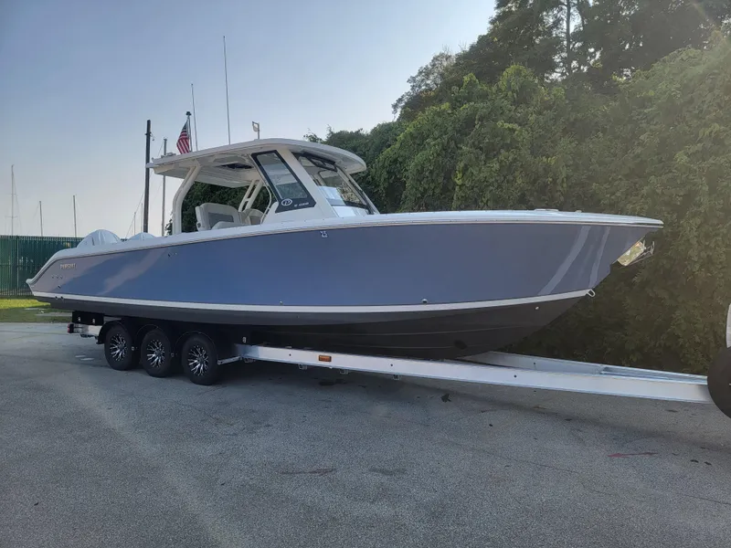 Slide: The Image of 2023 Pursuit S 328 Sport boat on trailer, parked outdoors. - 37