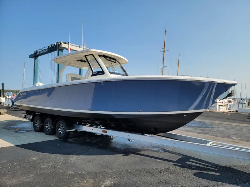 Slide: The Image of 2023 Pursuit S 328 Sport boat on trailer at marina, side view. - 39