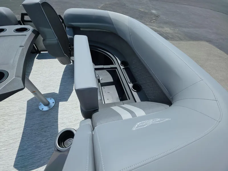 Slide: The Image of 2025 Bennington M Line boat interior with gray seating and storage compartments. - 13