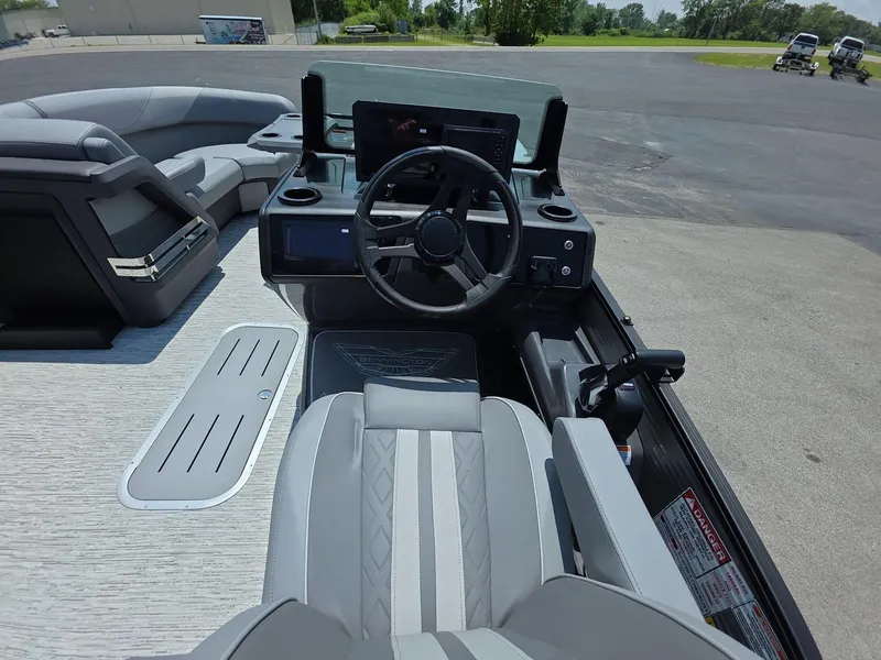 Slide: The Image of 2025 Bennington M Line boat interior with steering wheel and seating. - 15