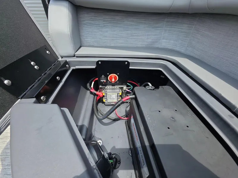 Slide: The Image of 2025 Bennington M Line boat battery compartment with wiring and switch. - 21