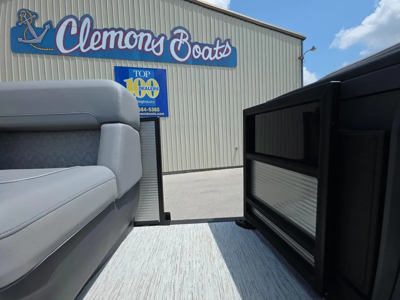 Slide: The Image of 2025 Bennington M Line boat at Clemons Boats dealership, showcasing interior seating. - 6