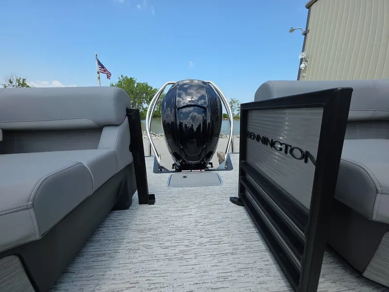 Slide: The Image of 2025 Bennington M Line boat interior with seating and motor, American flag in background. - 8