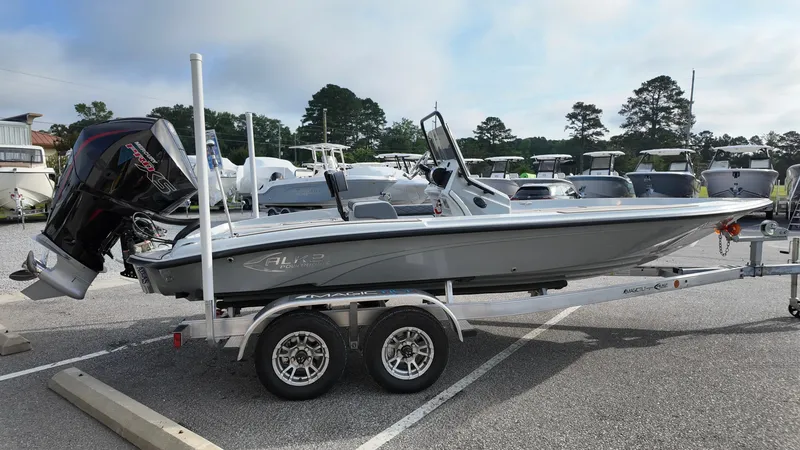 Slide: The Image of 2025 ALK2 Powerboats 21 BHX on trailer, parked in a marina lot. - 13