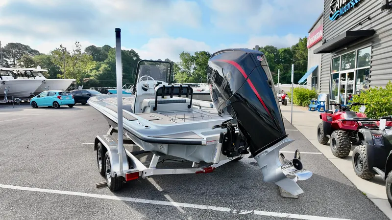 Slide: The Image of 2025 ALK2 Powerboats 21 BHX on trailer, parked outside dealership, showcasing sleek design and powerful engine. - 16