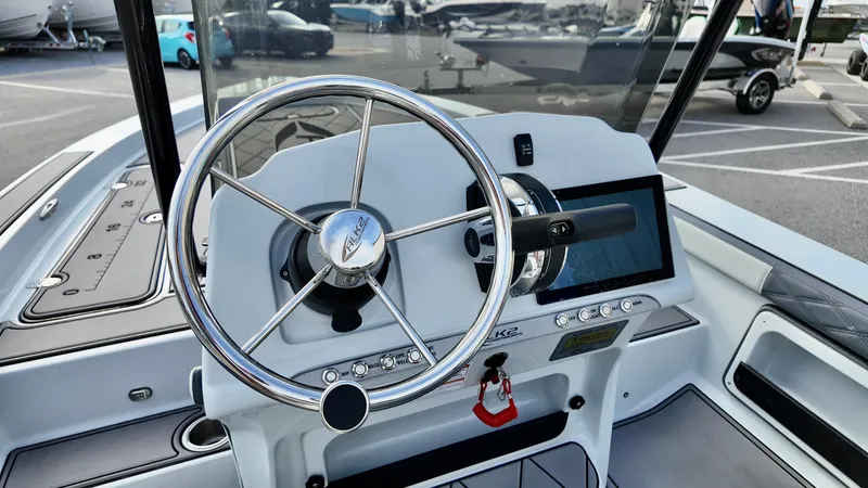 Slide: The Image of Steering wheel and dashboard of 2025 ALK2 Powerboats 21 BHX, featuring modern controls and touchscreen. - 8