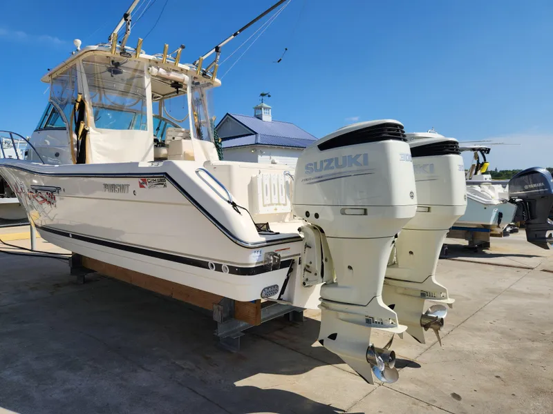 Slide: The Image of 2005 Pursuit 3070 Offshore Center Console boat with twin Suzuki outboard engines. - 11