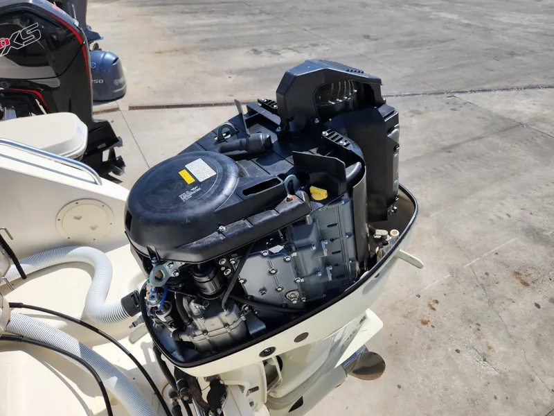 Slide: The Image of Open outboard motor on a 2005 Pursuit 3070 Offshore Center Console boat. - 14