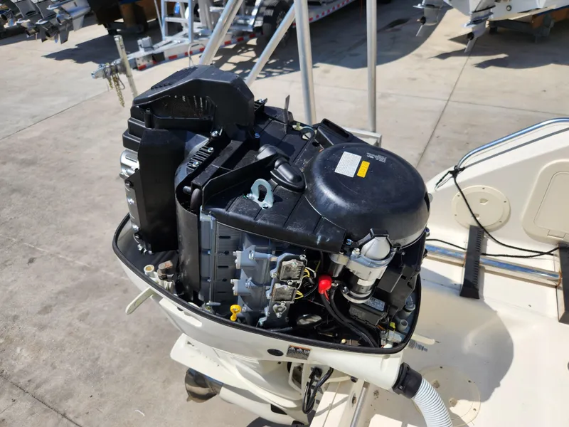 Slide: The Image of 2005 Pursuit 3070 Offshore Center Console engine, detailed view, outdoor setting. - 17