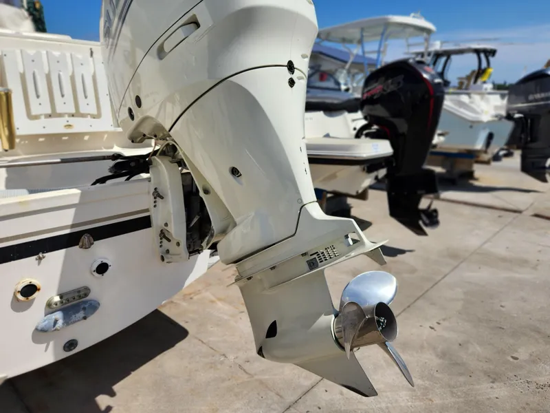 Slide: The Image of 2005 Pursuit 3070 Offshore Center Console boat with outboard motor, docked in marina. - 21