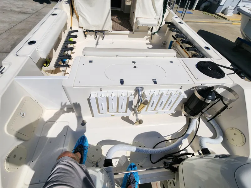 Slide: The Image of 2005 Pursuit 3070 Offshore Center Console boat interior with fishing gear and equipment. - 23