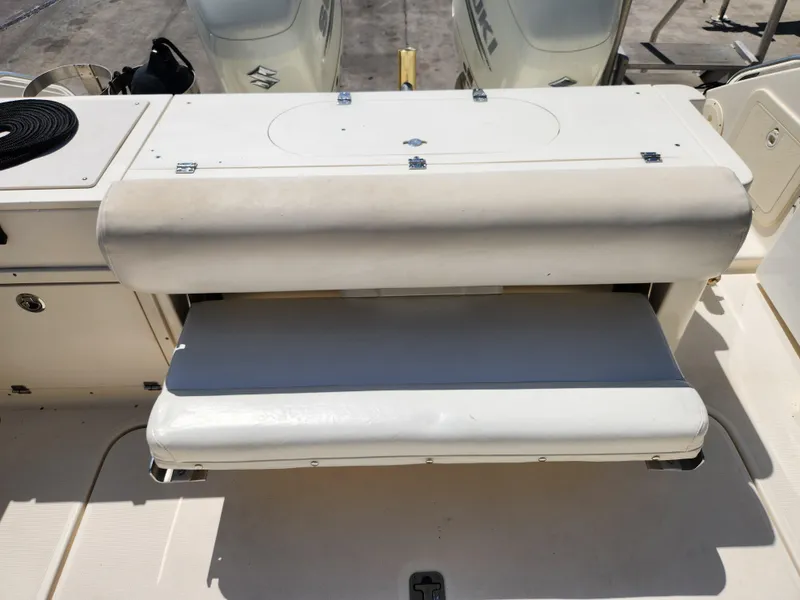 Slide: The Image of 2005 Pursuit 3070 Offshore Center Console boat seat and storage area. - 26