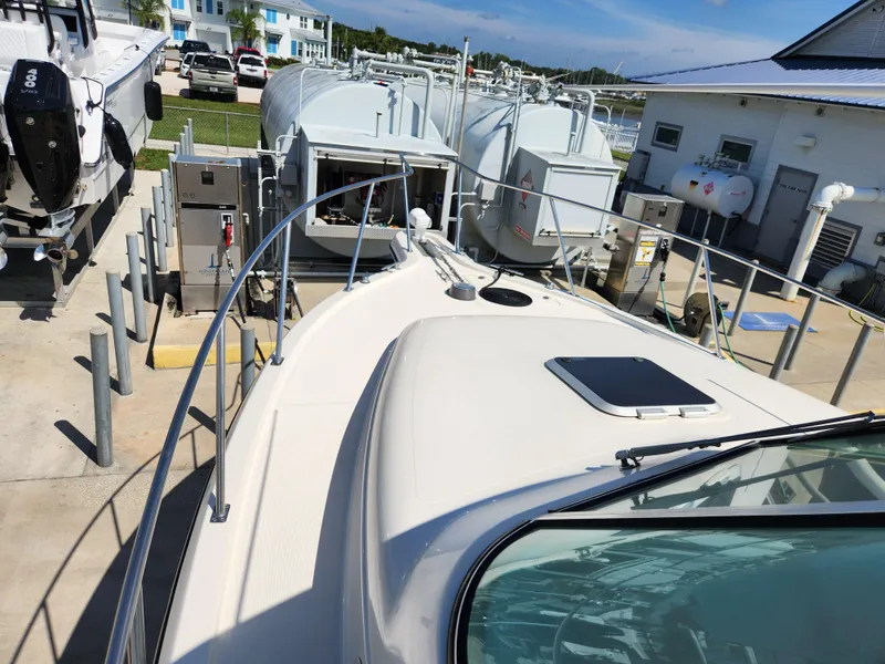 Slide: The Image of 2005 Pursuit 3070 Offshore Center Console boat docked at a marina. - 37