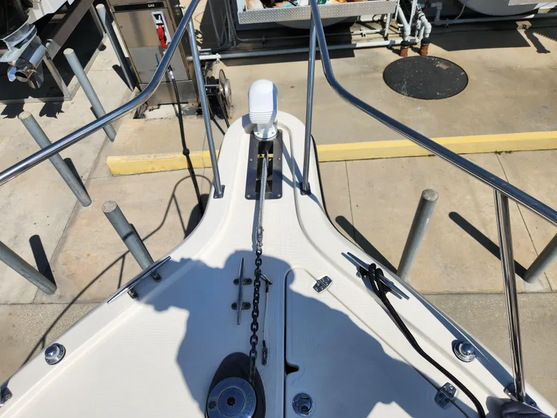 Slide: The Image of 2005 Pursuit 3070 Offshore Center Console boat deck with anchor chain and railing. - 38