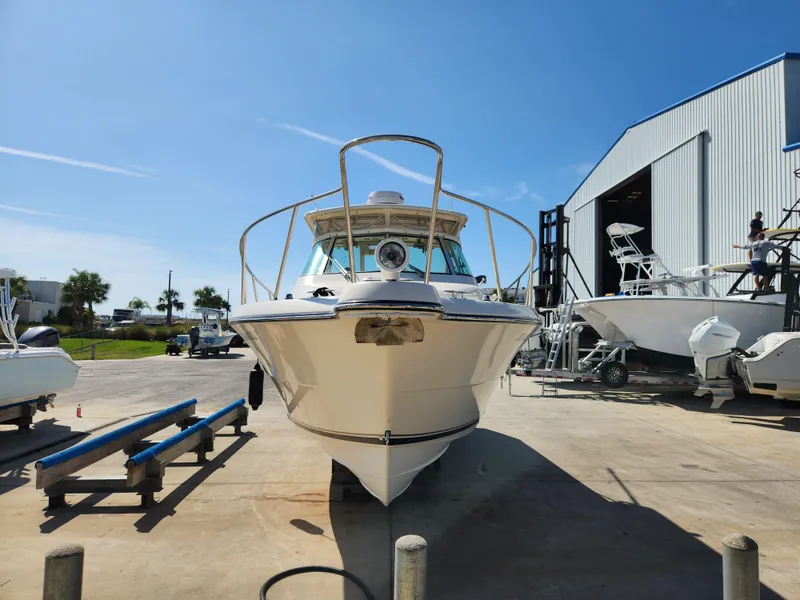 Slide: The Image of 2005 Pursuit 3070 Offshore Center Console boat in a marina, sunny day. - 6