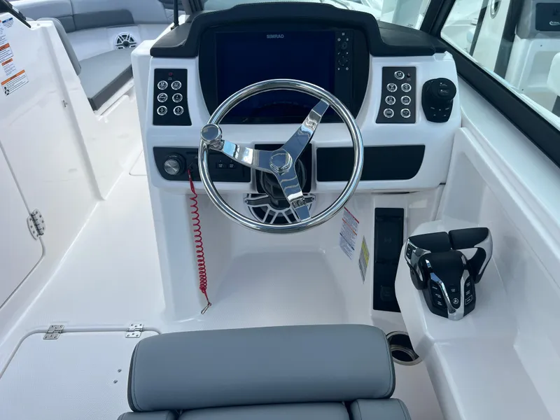 Slide: The Image of 2025 Robalo R257 Dual Console boat cockpit with modern steering and controls. - 11