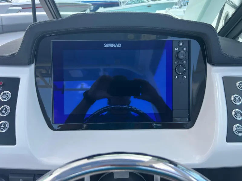 Slide: The Image of Simrad display on 2025 Robalo R257 Dual Console boat dashboard. - 12