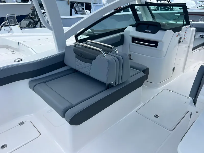 Slide: The Image of 2025 Robalo R257 Dual Console boat interior with sleek gray seating and modern design. - 13
