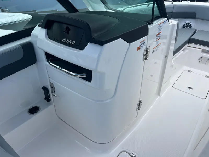 Slide: The Image of 2025 Robalo R257 Dual Console boat interior with storage compartment and seating area. - 16