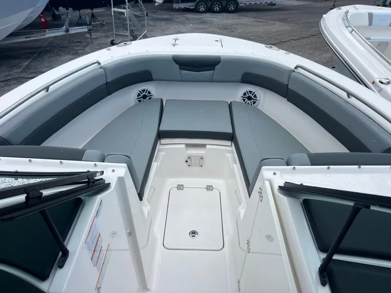 Slide: The Image of 2025 Robalo R257 Dual Console boat interior with gray seating and storage compartments. - 18