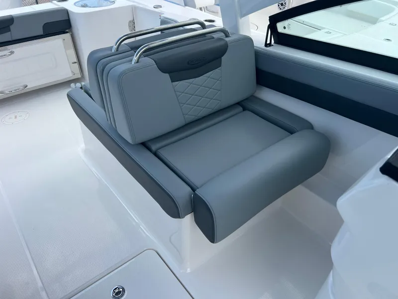 Slide: The Image of 2025 Robalo R257 Dual Console boat seat, gray upholstery, modern design. - 23