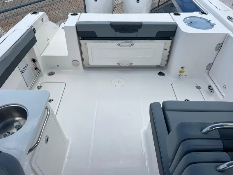 Slide: The Image of 2025 Robalo R257 Dual Console boat interior with seating, storage, and sink. - 25