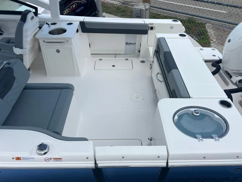 Slide: The Image of 2025 Robalo R257 Dual Console boat interior with seating and storage compartments. - 27