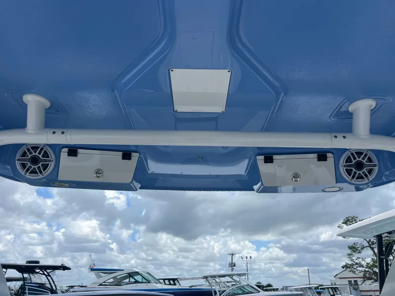 Slide: The Image of 2025 Robalo R257 Dual Console boat speakers and canopy against a cloudy sky. - 31