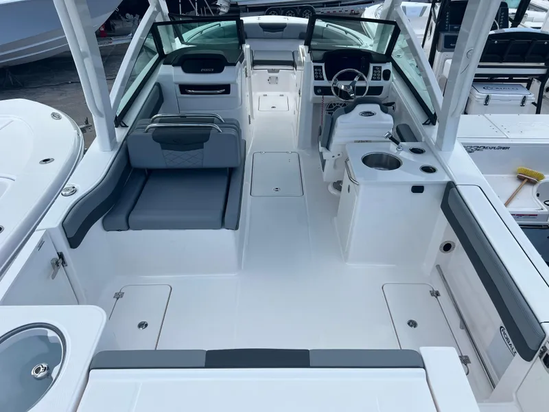 Slide: The Image of 2025 Robalo R257 Dual Console boat interior with seating, steering wheel, and storage compartments. - 7