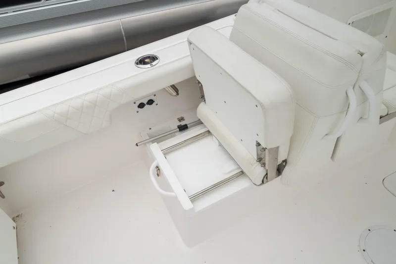 Slide: The Image of 2023 Edgewater 248 CX boat seat with storage drawer, white upholstery. - 11