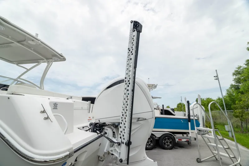 Slide: The Image of 2023 Edgewater 248 CX boat with a mounted power pole, parked on a trailer. - 15