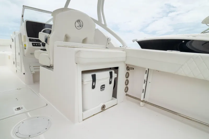 Slide: The Image of 2023 Edgewater 248 CX boat interior with seating and storage compartment. - 17