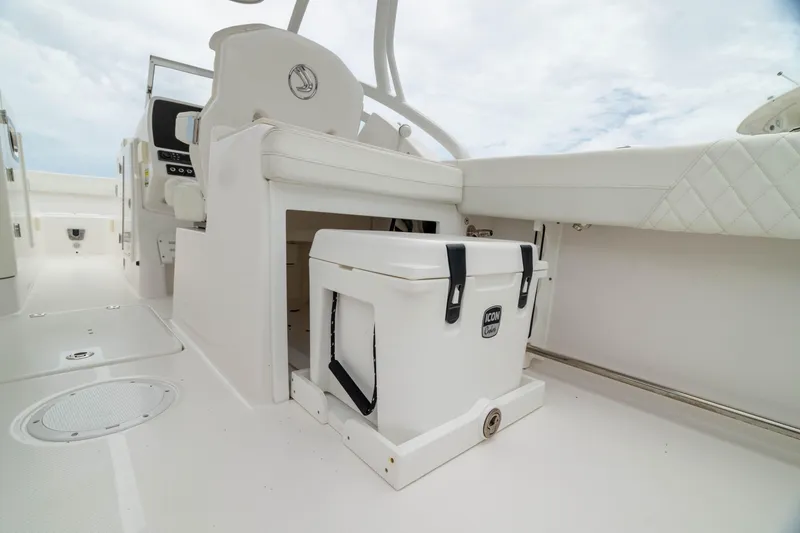 Slide: The Image of 2023 Edgewater 248 CX boat interior with storage compartment and cooler. - 18
