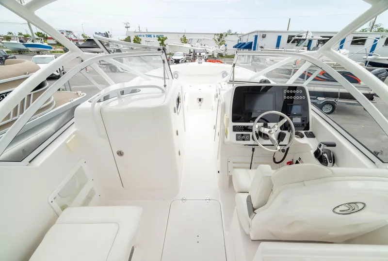 Slide: The Image of 2023 Edgewater 248 CX boat interior with modern dashboard and seating. - 21