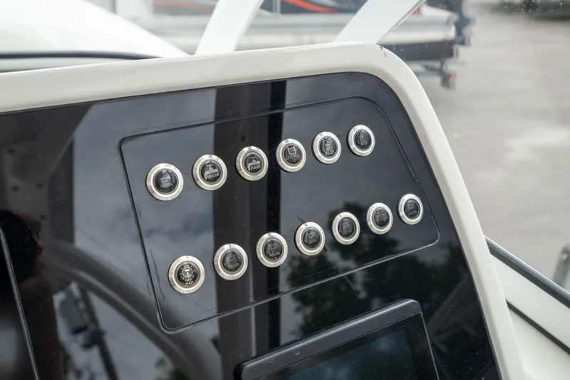 Slide: The Image of Dashboard controls of 2023 Edgewater 248 CX boat, featuring multiple buttons and sleek design. - 22