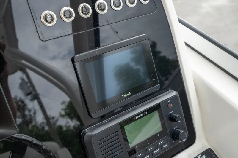 Slide: The Image of Dashboard of 2023 Edgewater 248 CX with Yamaha and Garmin displays. - 23
