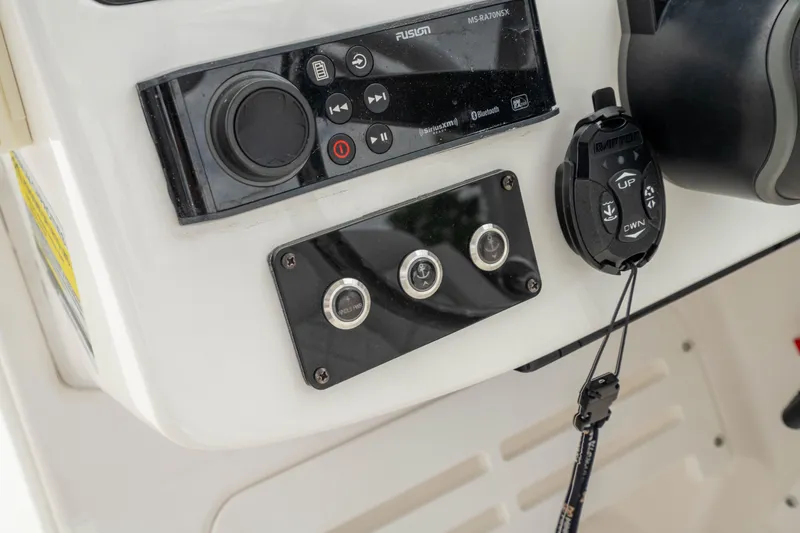 Slide: The Image of Control panel of 2023 Edgewater 248 CX boat featuring audio system and controls. - 26