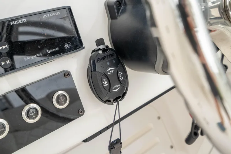 Slide: The Image of Edgewater 248 CX 2023 boat dashboard with controls and Fusion audio system. - 27