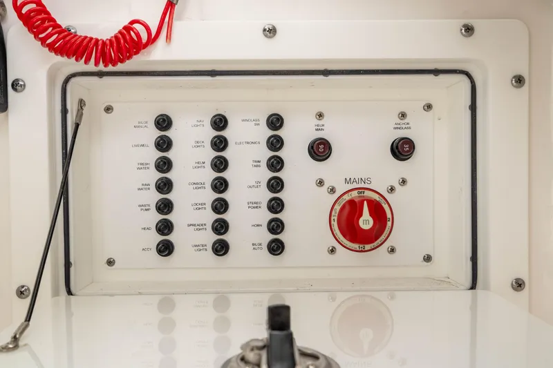 Slide: The Image of Electrical control panel on 2023 Edgewater 248 CX boat with switches and main power dial. - 32