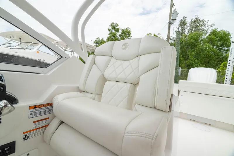 Slide: The Image of 2023 Edgewater 248 CX boat interior with luxurious white seating and modern design. - 35