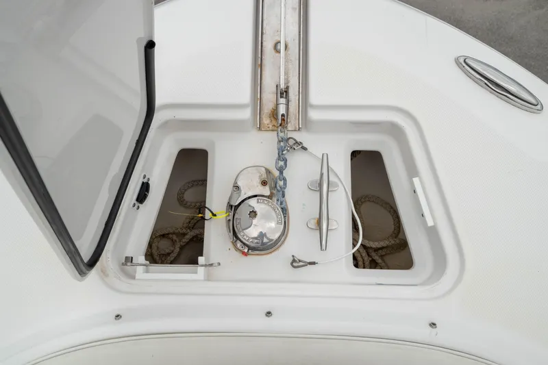 Slide: The Image of Anchor storage compartment on 2023 Edgewater 248 CX boat, featuring chain and rope. - 43